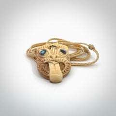 Hand carved Wheku pendant. Carved from woolly mammoth Tusk by NZ Pacific. Hand crafted Mammoth tusk jewellery for sale online. Provided with an adjustable cord and packaged in woven kete pouch.