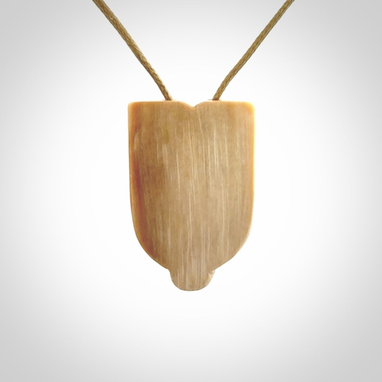 Hand carved Wheku pendant. Carved from woolly mammoth Tusk by NZ Pacific. Hand crafted Mammoth tusk jewellery for sale online. Provided with an adjustable cord and packaged in woven kete pouch.