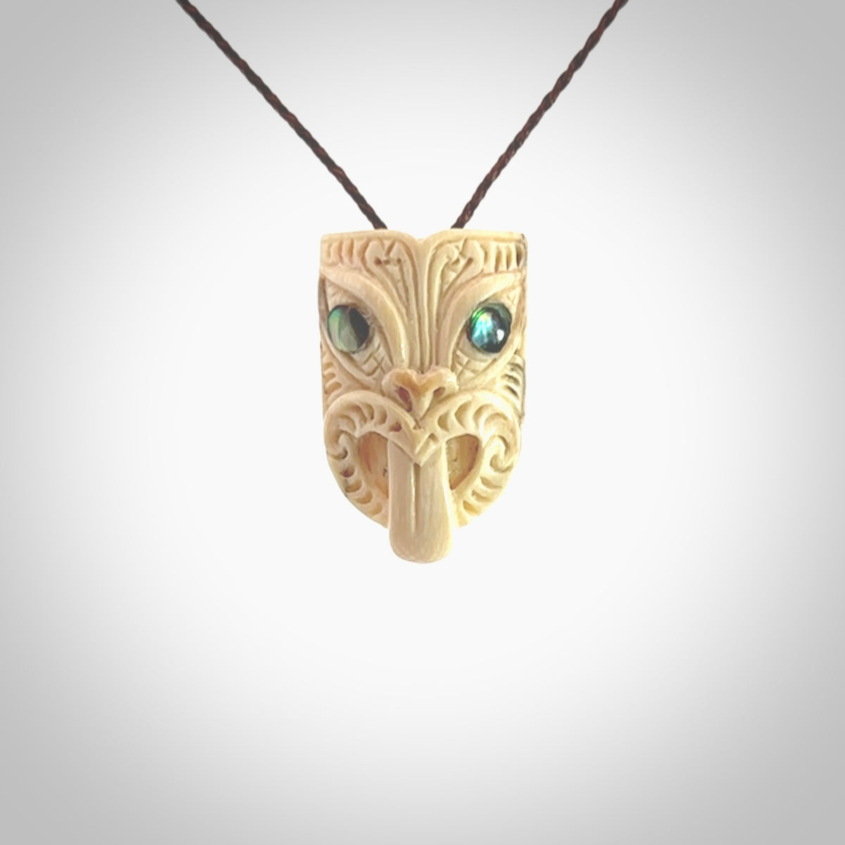 Hand carved Wheku pendant. Carved from woolly mammoth Tusk by NZ Pacific. Hand crafted Mammoth tusk jewellery for sale online. Provided with an adjustable cord and packaged in woven kete pouch.