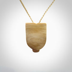 Hand carved Wheku pendant. Carved from woolly mammoth Tusk by NZ Pacific. Hand crafted Mammoth tusk jewellery for sale online. Provided with an adjustable cord and packaged in woven kete pouch.