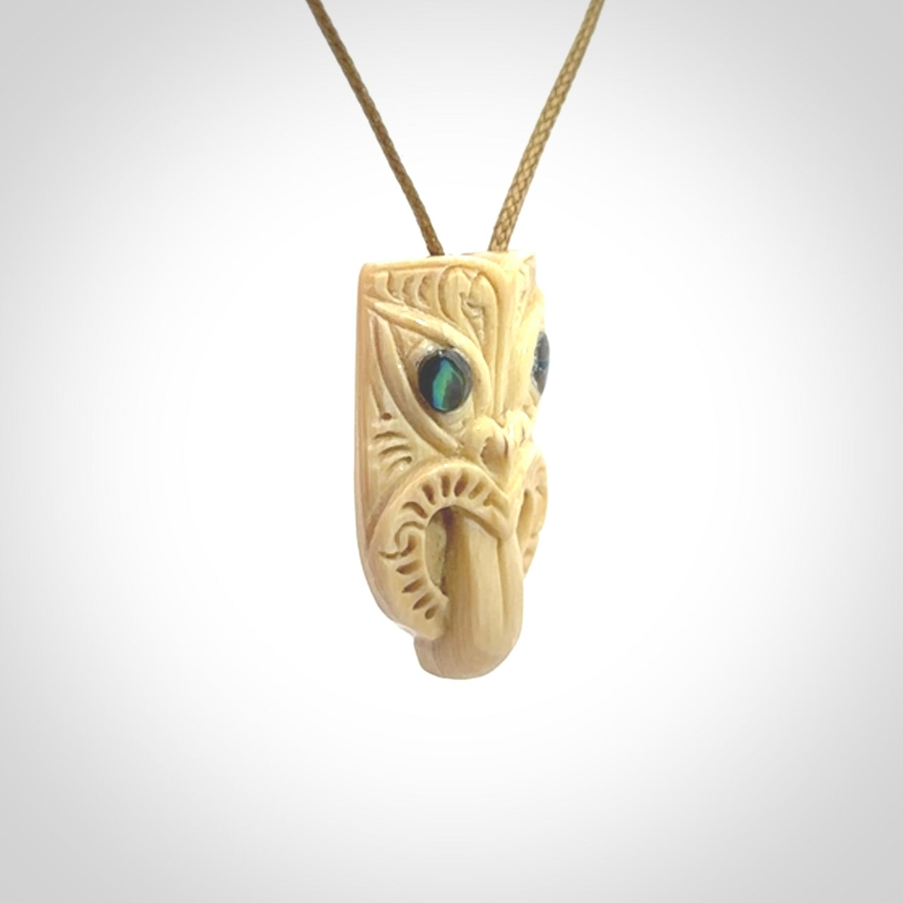 Hand carved Wheku pendant. Carved from woolly mammoth Tusk by NZ Pacific. Hand crafted Mammoth tusk jewellery for sale online. Provided with an adjustable cord and packaged in woven kete pouch.