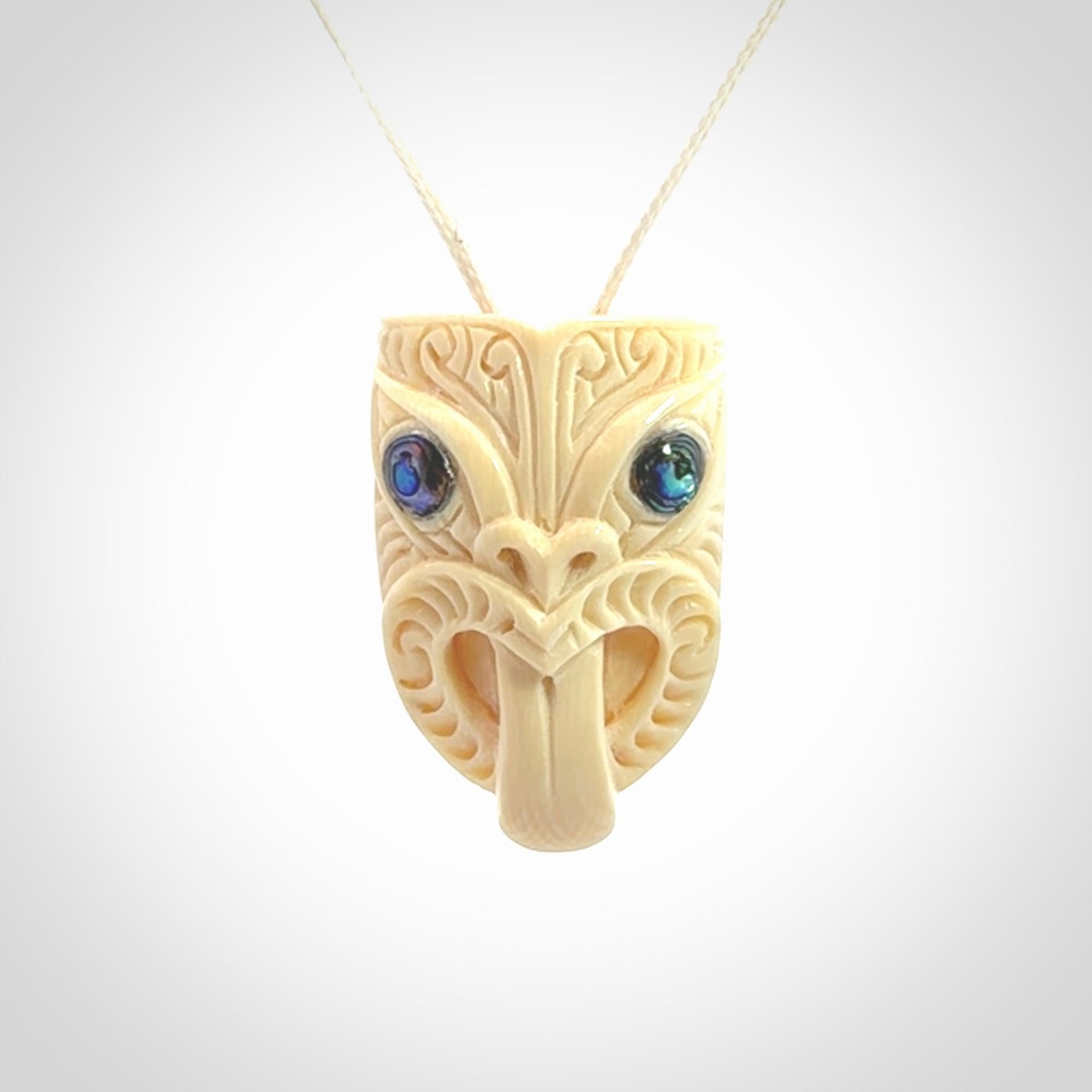 Hand carved Wheku pendant. Carved from woolly mammoth Tusk by NZ Pacific. Hand crafted Mammoth tusk jewellery for sale online. Provided with an adjustable cord and packaged in woven kete pouch.