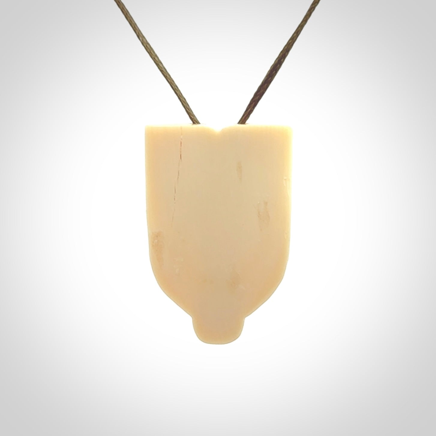 Hand carved Wheku pendant. Carved from woolly mammoth Tusk by NZ Pacific. Hand crafted Mammoth tusk jewellery for sale online. Provided with an adjustable cord and packaged in woven kete pouch.