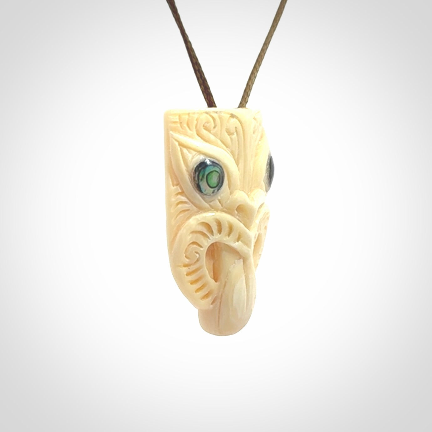 Hand carved Wheku pendant. Carved from woolly mammoth Tusk by NZ Pacific. Hand crafted Mammoth tusk jewellery for sale online. Provided with an adjustable cord and packaged in woven kete pouch.