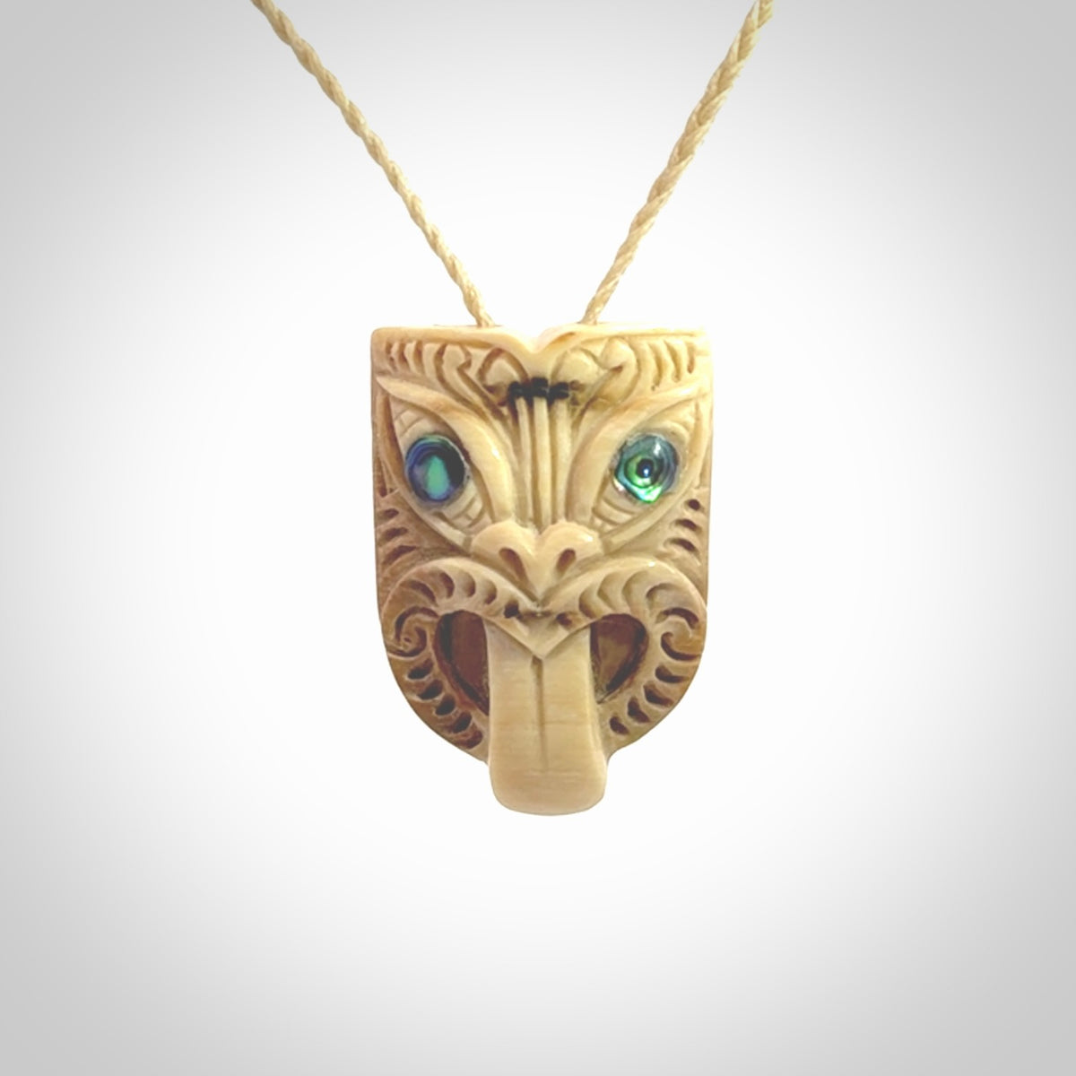 Hand carved Wheku pendant. Carved from woolly mammoth Tusk by NZ Pacific. Hand crafted Mammoth tusk jewellery for sale online. Provided with an adjustable cord and packaged in woven kete pouch.
