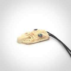 Hand carved Wheku pendant. Carved from woolly mammoth Tusk by NZ Pacific. Hand crafted Mammoth tusk jewellery for sale online. Provided with an adjustable cord and packaged in woven kete pouch.