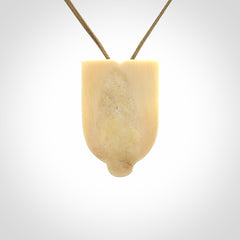 Hand carved Wheku pendant. Carved from woolly mammoth Tusk by NZ Pacific. Hand crafted Mammoth tusk jewellery for sale online. Provided with an adjustable cord and packaged in woven kete pouch.
