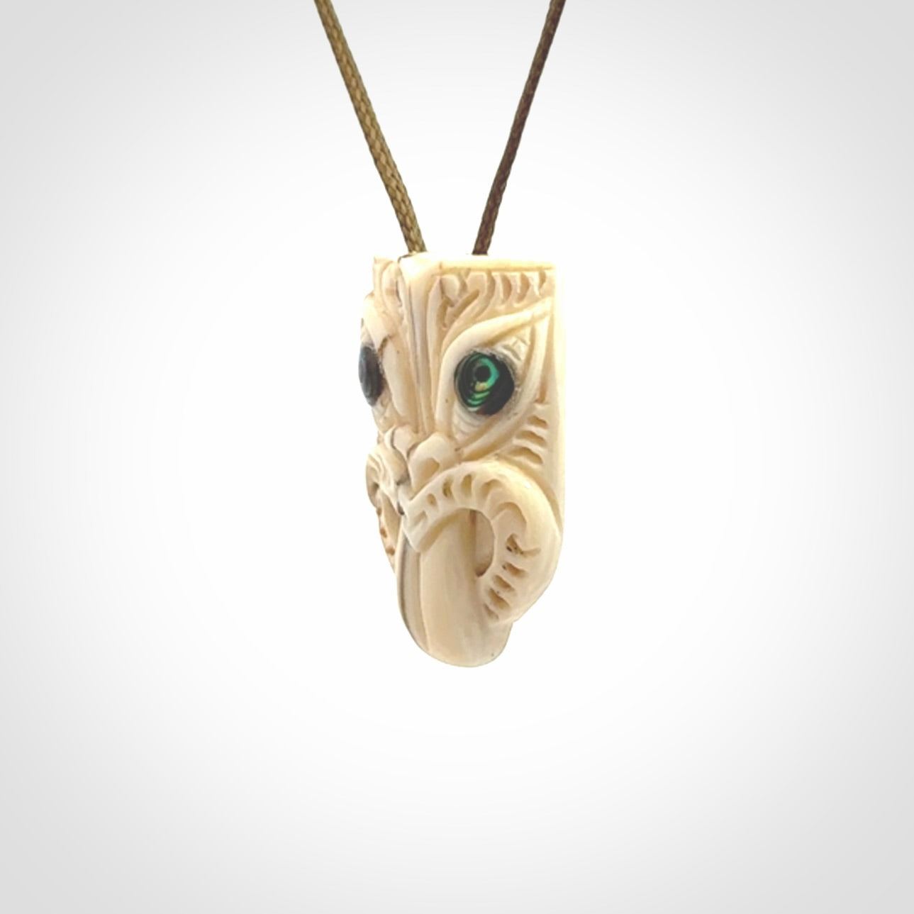 Hand carved Wheku pendant. Carved from woolly mammoth Tusk by NZ Pacific. Hand crafted Mammoth tusk jewellery for sale online. Provided with an adjustable cord and packaged in woven kete pouch.