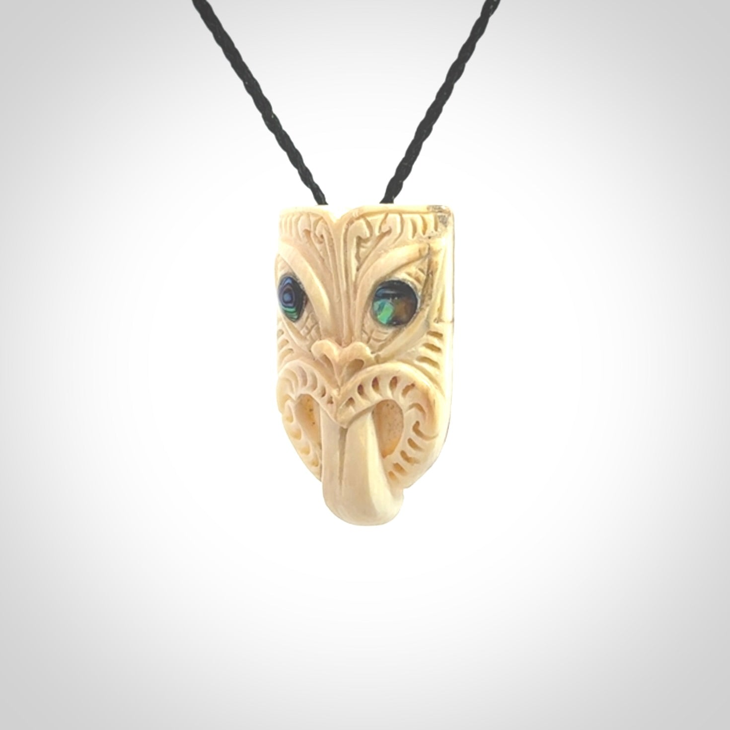 Hand carved Wheku pendant. Carved from woolly mammoth Tusk by NZ Pacific. Hand crafted Mammoth tusk jewellery for sale online. Provided with an adjustable cord and packaged in woven kete pouch.