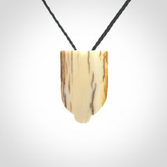 Hand carved Wheku pendant. Carved from woolly mammoth Tusk by NZ Pacific. Hand crafted Mammoth tusk jewellery for sale online. Provided with an adjustable cord and packaged in woven kete pouch.