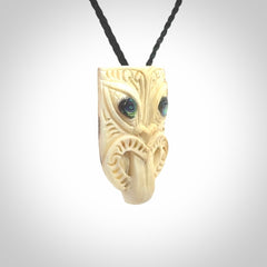 Hand carved Wheku pendant. Carved from woolly mammoth Tusk by NZ Pacific. Hand crafted Mammoth tusk jewellery for sale online. Provided with an adjustable cord and packaged in woven kete pouch.