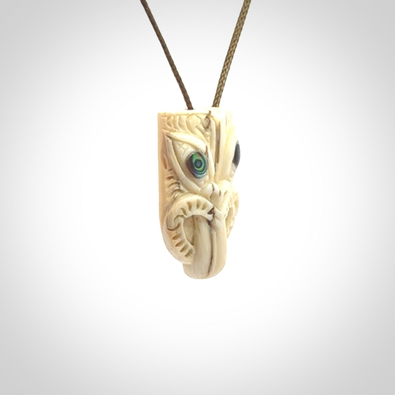Hand carved Wheku pendant. Carved from woolly mammoth Tusk by NZ Pacific. Hand crafted Mammoth tusk jewellery for sale online. Provided with an adjustable cord and packaged in woven kete pouch.