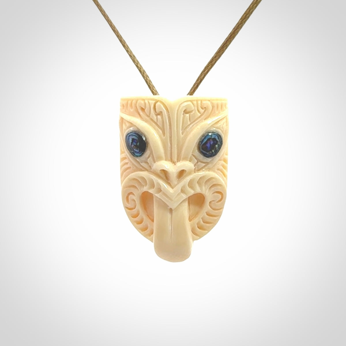 Hand carved Wheku pendant. Carved from woolly mammoth Tusk by NZ Pacific. Hand crafted Mammoth tusk jewellery for sale online. Provided with an adjustable cord and packaged in woven kete pouch.