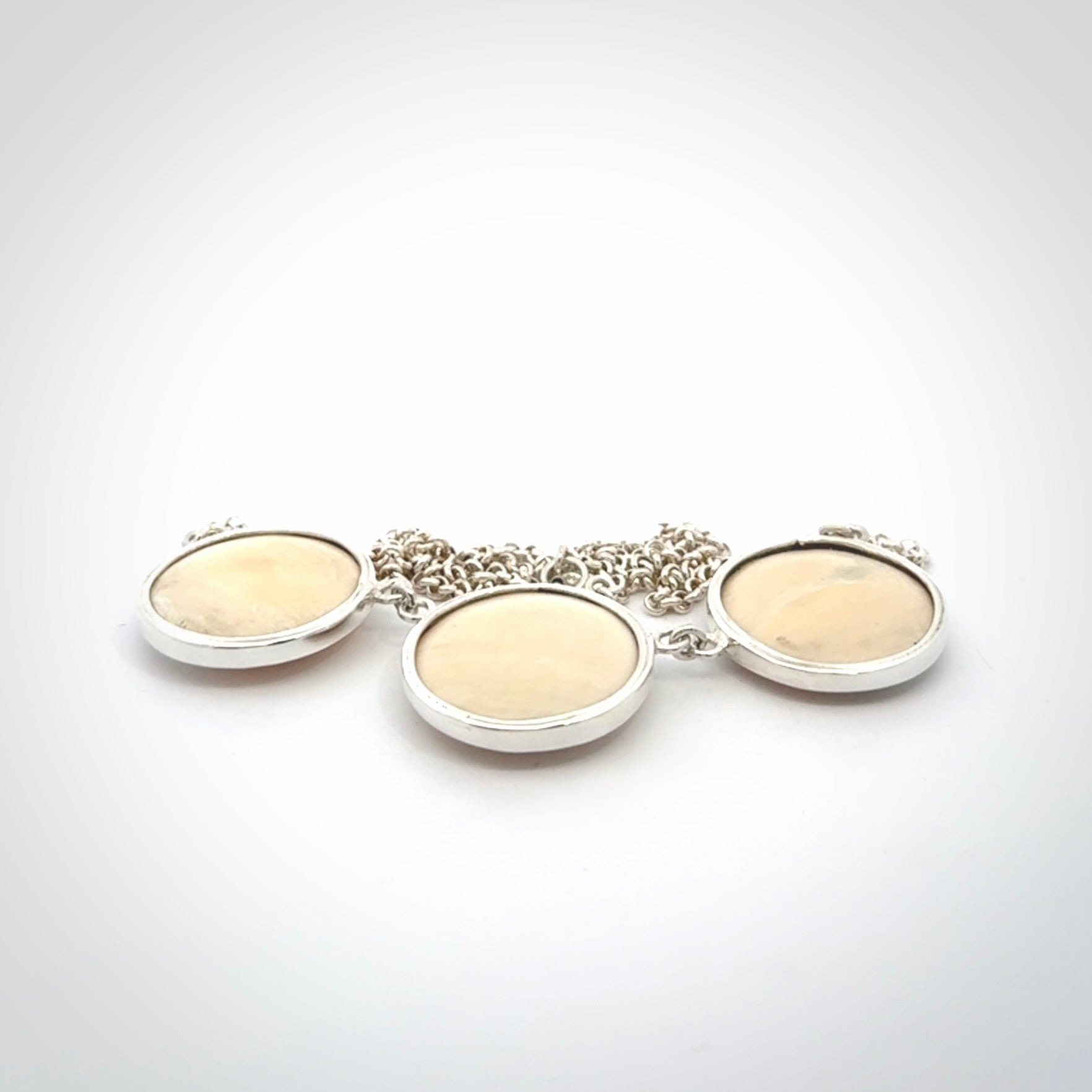 Hand made woolly mammoth tusk triple drop necklace with Sterling Silver. Mammoth tusk triple drop pendant with Sterling silver surround and chain. Made by NZ Pacific and sale online only. Packaged in a woven kete pouch and shipped to you with Express Courier.