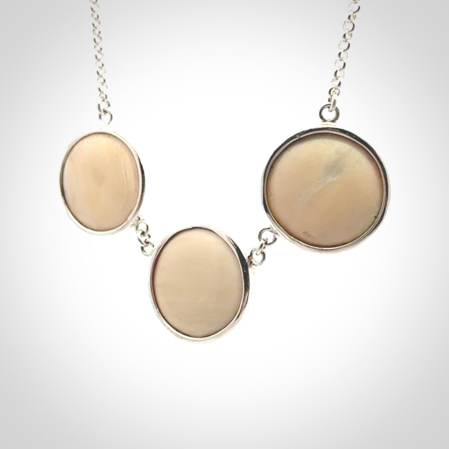 Hand made woolly mammoth tusk triple drop necklace with Sterling Silver. Mammoth tusk triple drop pendant with Sterling silver surround and chain. Made by NZ Pacific and sale online only. Packaged in a woven kete pouch and shipped to you with Express Courier.