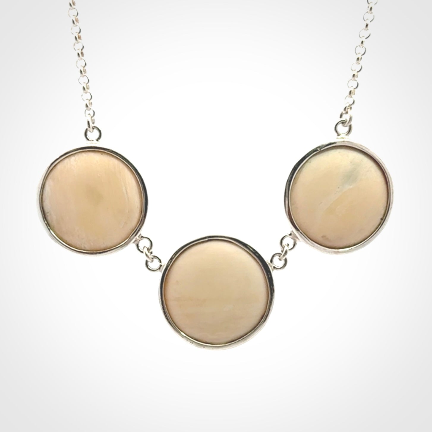 Hand made woolly mammoth tusk triple drop necklace with Sterling Silver. Mammoth tusk triple drop pendant with Sterling silver surround and chain. Made by NZ Pacific and sale online only. Packaged in a woven kete pouch and shipped to you with Express Courier.