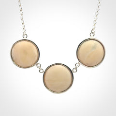 Hand made woolly mammoth tusk triple drop necklace with Sterling Silver. Mammoth tusk triple drop pendant with Sterling silver surround and chain. Made by NZ Pacific and sale online only. Packaged in a woven kete pouch and shipped to you with Express Courier.