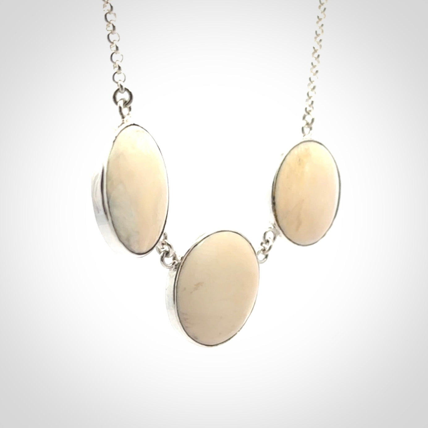 Hand made woolly mammoth tusk triple drop necklace with Sterling Silver. Mammoth tusk triple drop pendant with Sterling silver surround and chain. Made by NZ Pacific and sale online only. Packaged in a woven kete pouch and shipped to you with Express Courier.