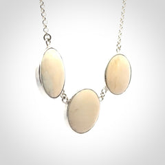Hand made woolly mammoth tusk triple drop necklace with Sterling Silver. Mammoth tusk triple drop pendant with Sterling silver surround and chain. Made by NZ Pacific and sale online only. Packaged in a woven kete pouch and shipped to you with Express Courier.