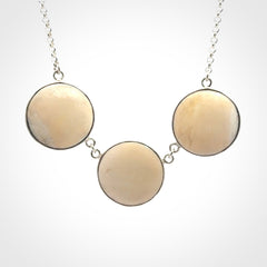 Hand made woolly mammoth tusk triple drop necklace with Sterling Silver. Mammoth tusk triple drop pendant with Sterling silver surround and chain. Made by NZ Pacific and sale online only. Packaged in a woven kete pouch and shipped to you with Express Courier.