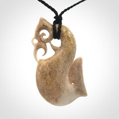 Hand made deer antler manaia pendant. Hand carved by NZ Pacific. Manaia carved from deer antler pendant for sale online. Delivered to you on an adjustable black cord and packaged in a woven kete pouch.