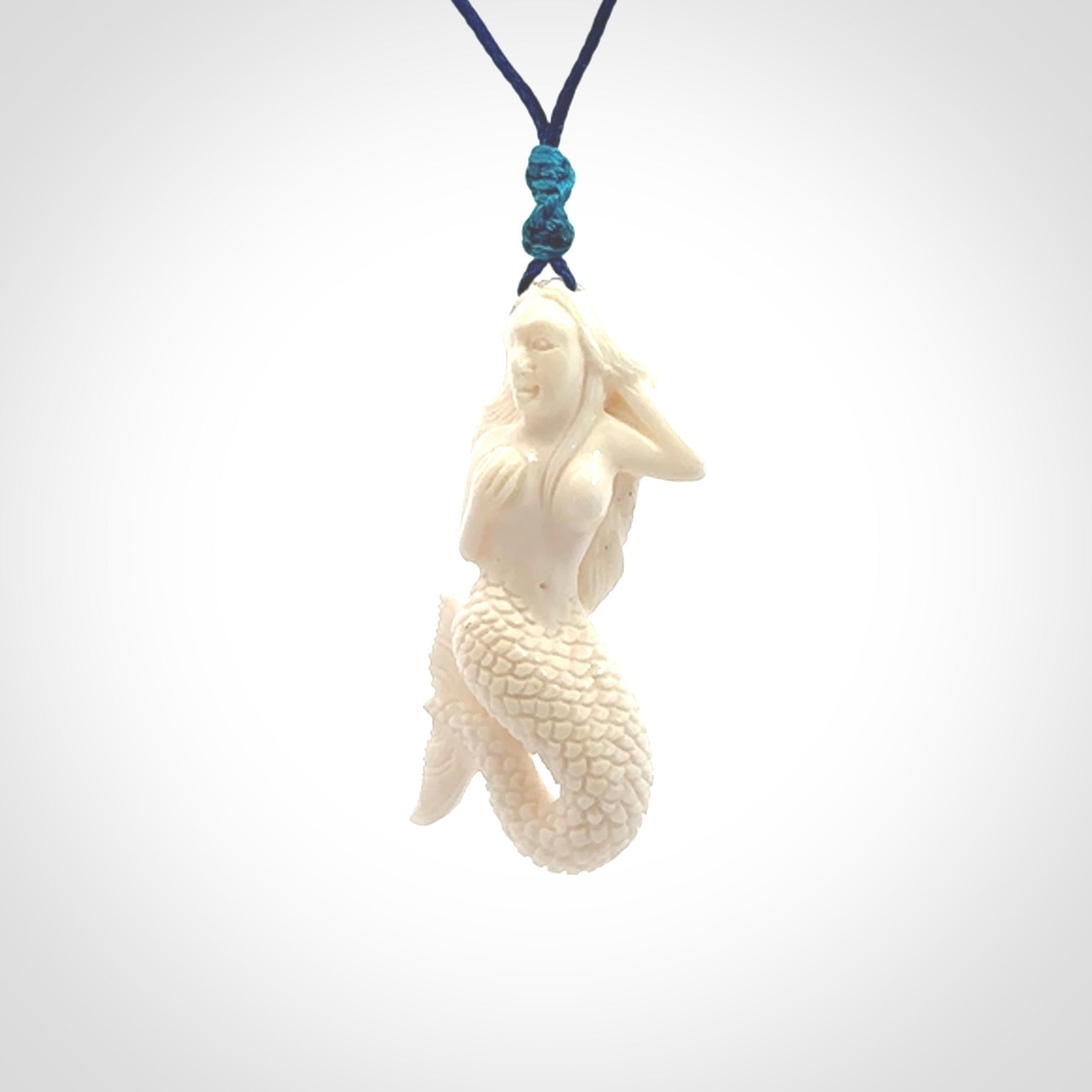 Hand carved natural bone mermaid pendant. Hand made from real bone. Art to wear. Provided with adjustable cord and packaged in a woven kete pouch.