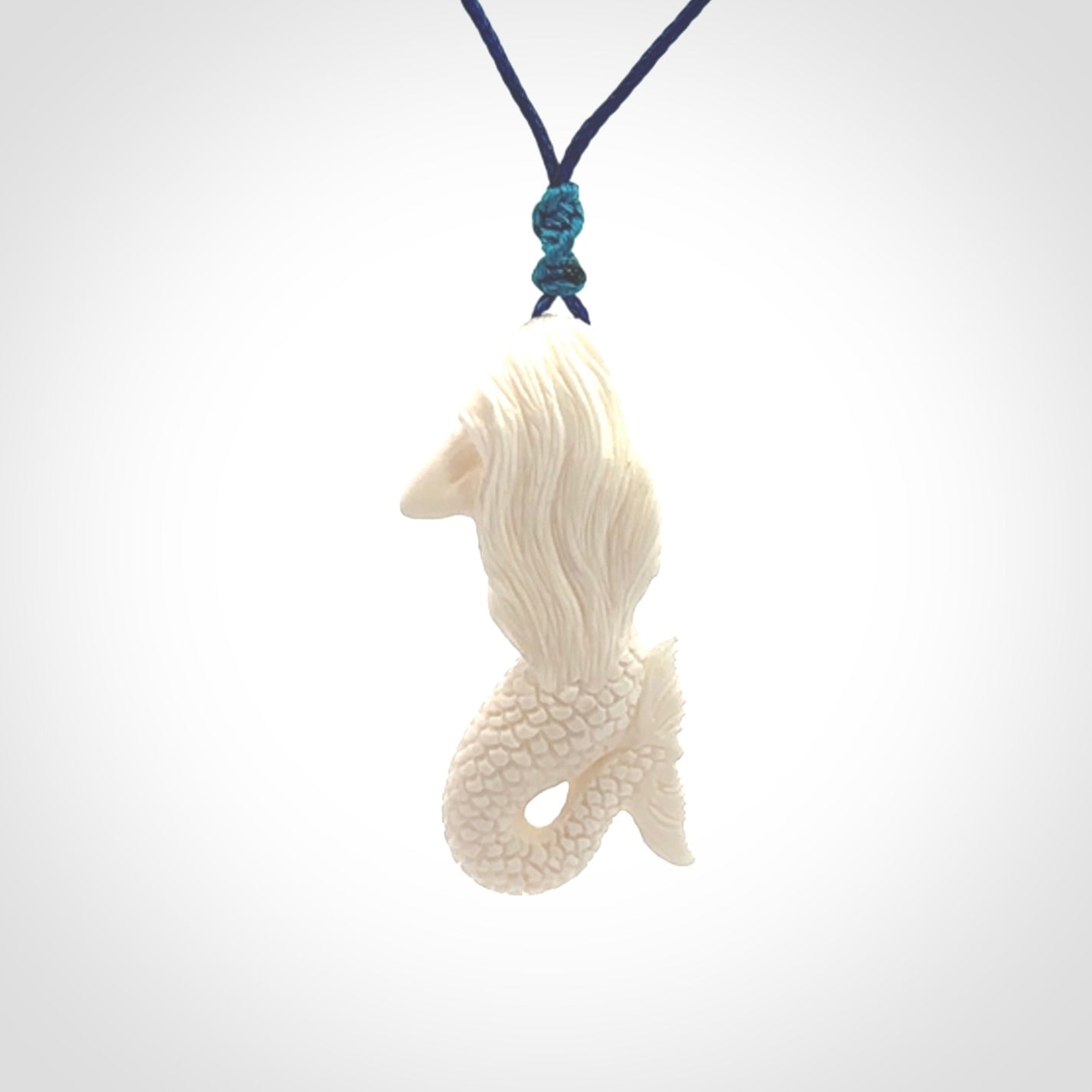 Hand carved natural bone mermaid pendant. Hand made from real bone. Art to wear. Provided with adjustable cord and packaged in a woven kete pouch.