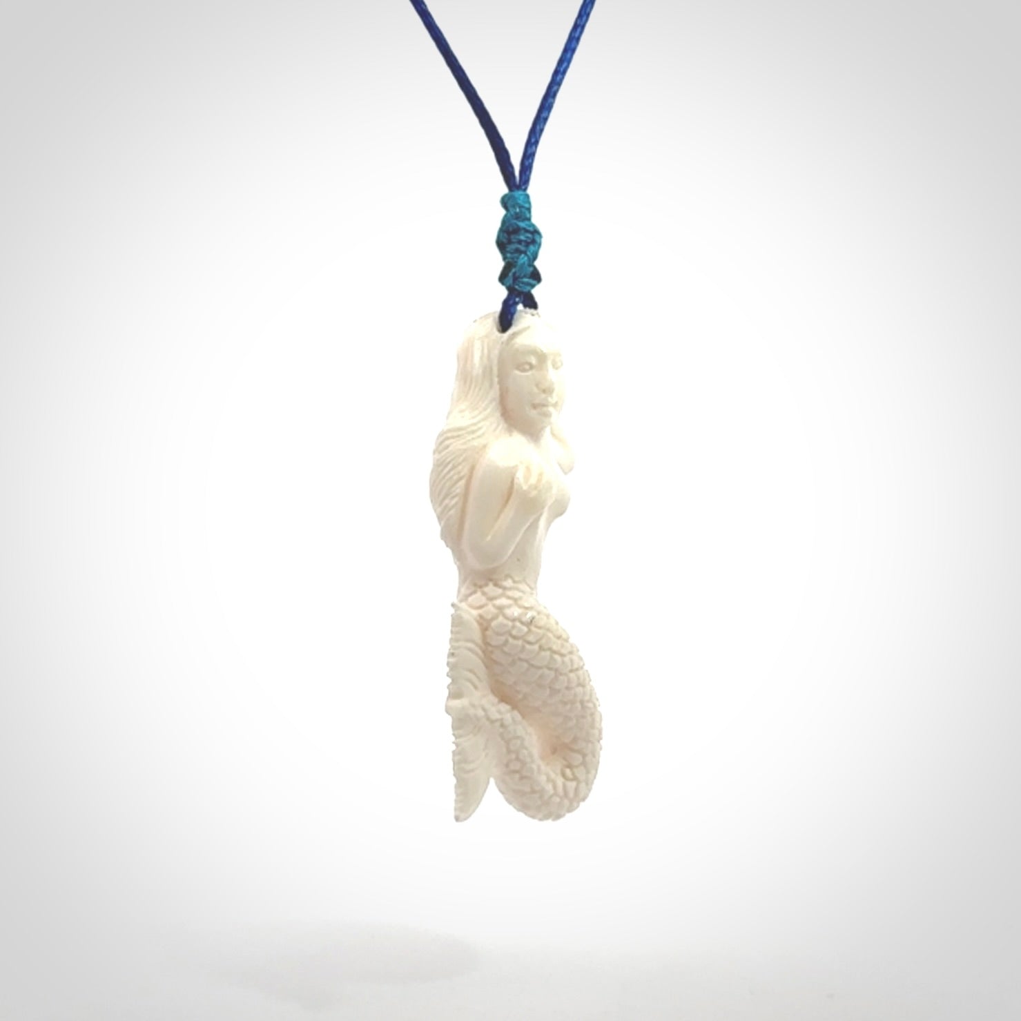 Hand carved natural bone mermaid pendant. Hand made from real bone. Art to wear. Provided with adjustable cord and packaged in a woven kete pouch.