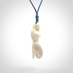 Hand carved natural bone mermaid pendant. Hand made from real bone. Art to wear. Provided with adjustable cord and packaged in a woven kete pouch.