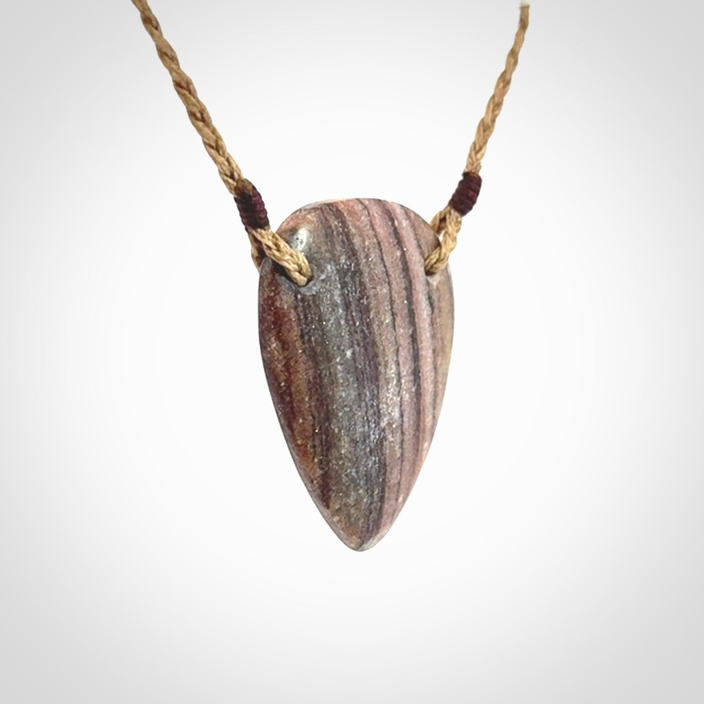 A hand carved drop pendant made from New Zealand Aroha Stone. This is a medium sized and visually striking piece, beautifully curved and sensuous. The perfect piece of jewellery for someone you love.
