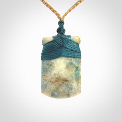 This is a handcrafted aotea stone Toki pendant.