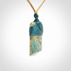 This is a handcrafted aotea stone Toki pendant.