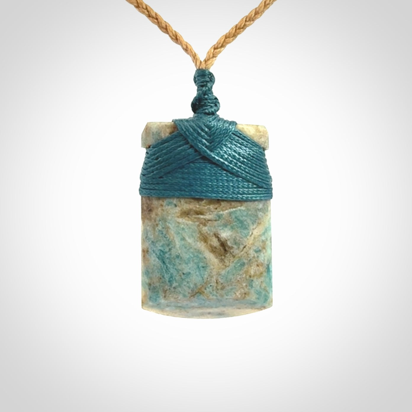 This is a handcrafted aotea stone Toki pendant.