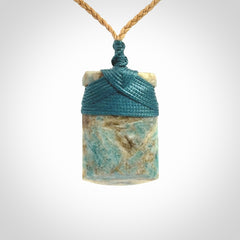 This is a handcrafted aotea stone Toki pendant.