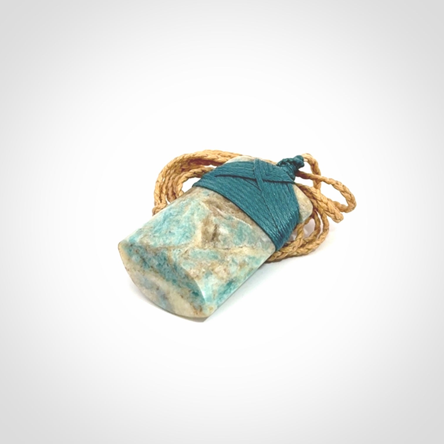 This is a handcrafted aotea stone Toki pendant.