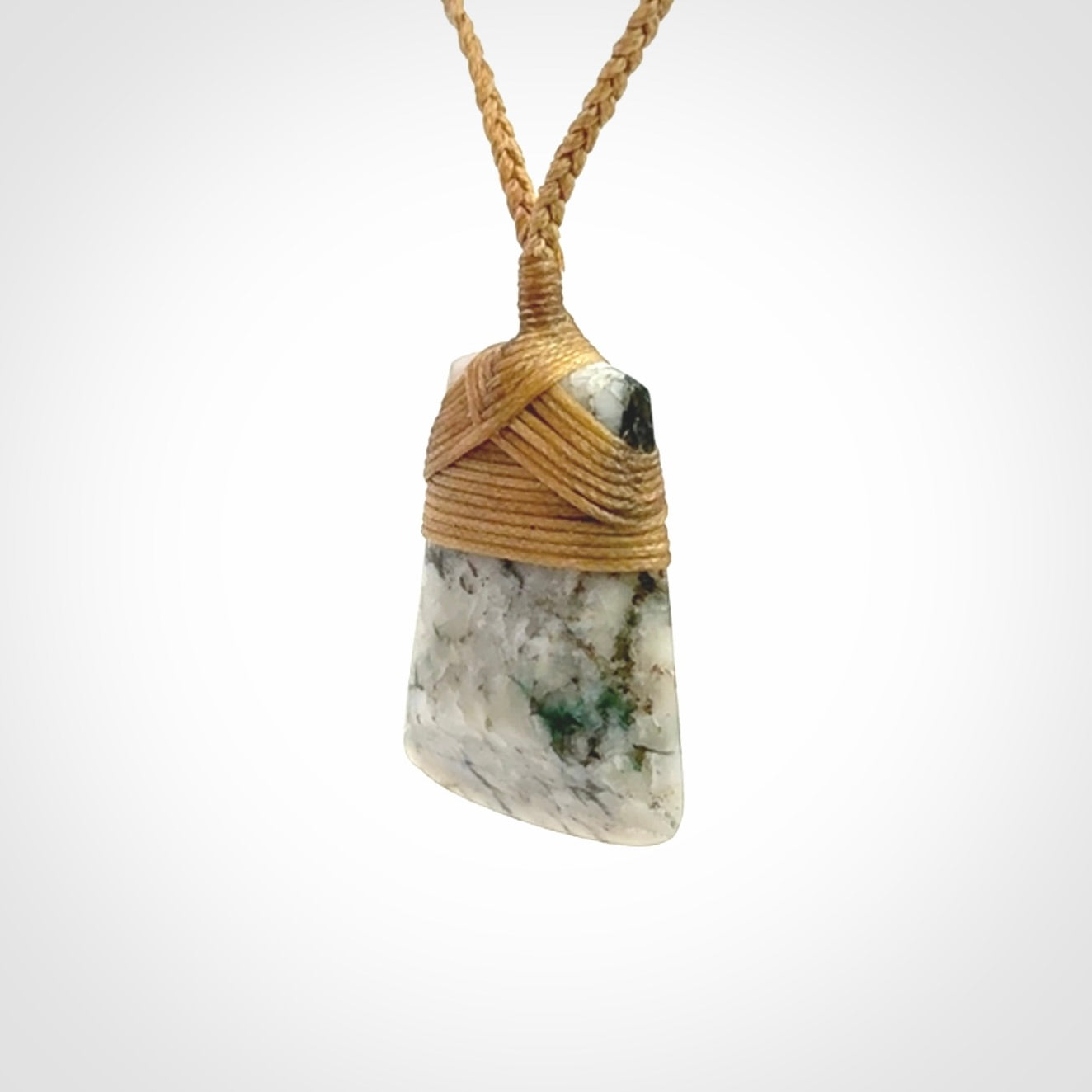 This is a handcrafted aotea stone Toki pendant.