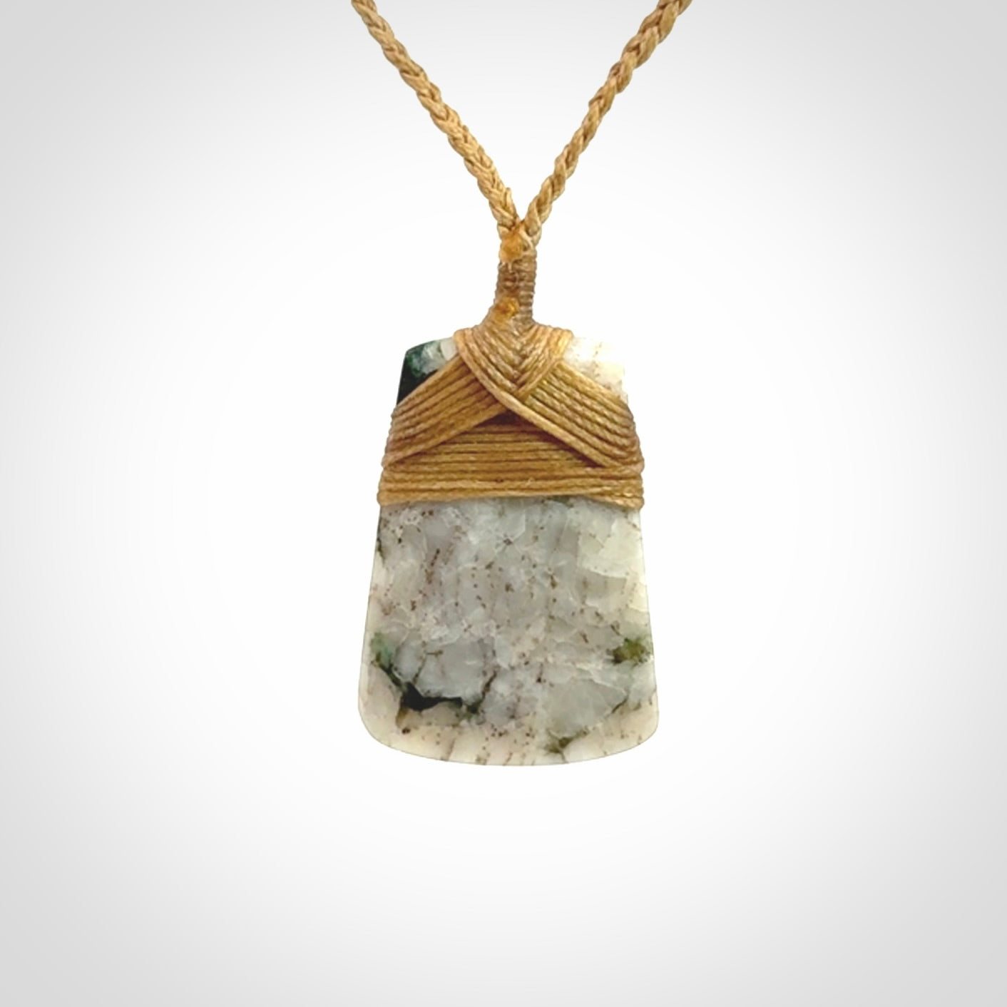 This is a handcrafted aotea stone Toki pendant.