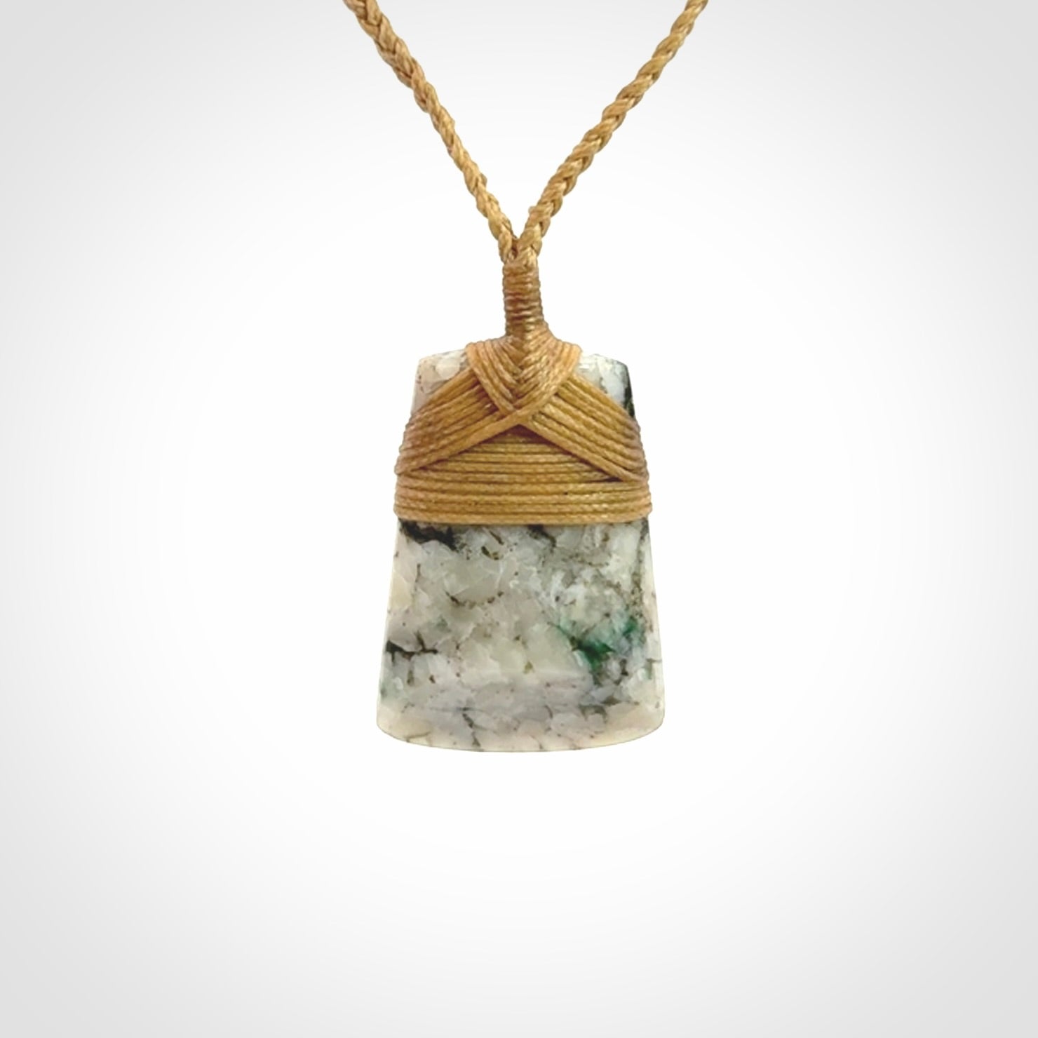 This is a handcrafted aotea stone Toki pendant.