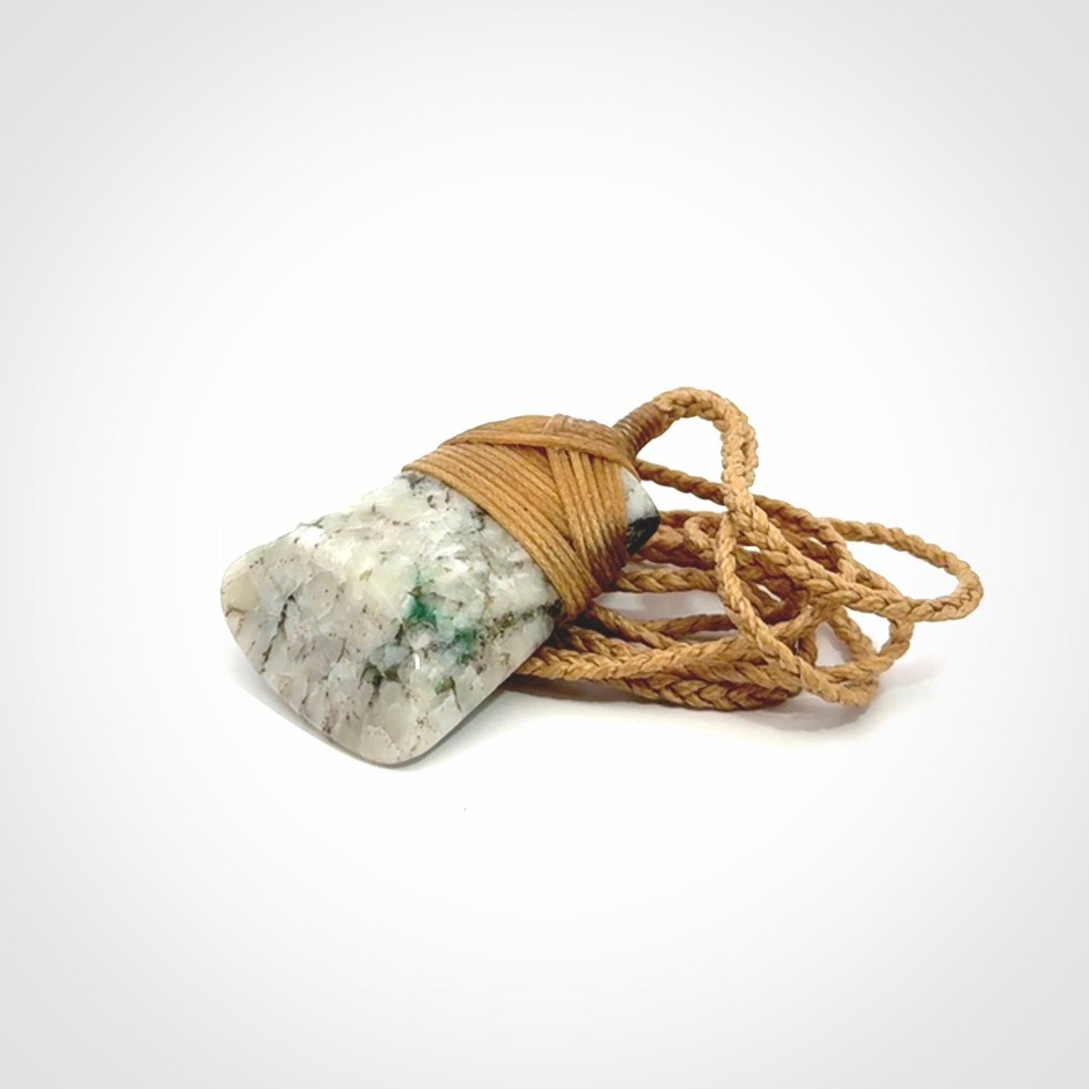 This is a handcrafted aotea stone Toki pendant.