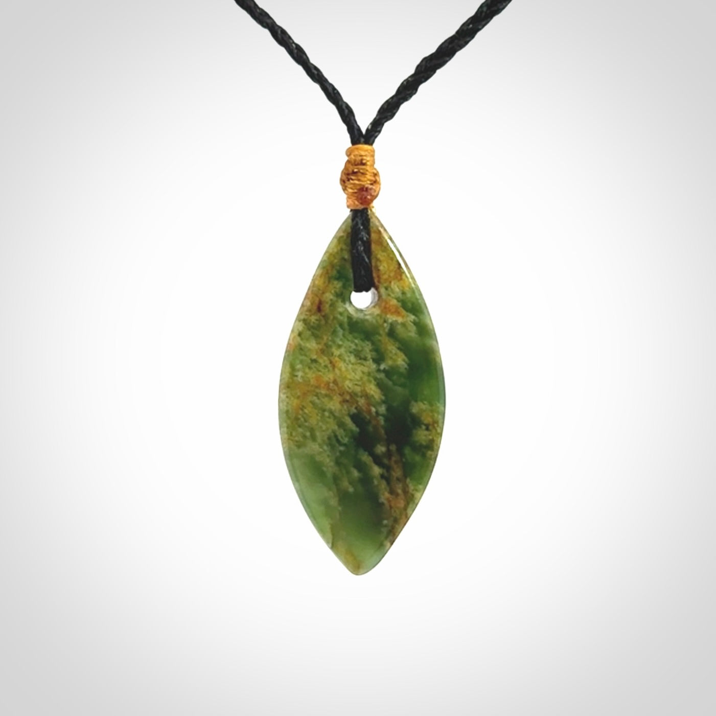 This picture shows a medium sized Flower Jade teardrop pendant. The pendant looks like a teardrop . A hand made unique and contemporary necklace hand carved here in New Zealand.