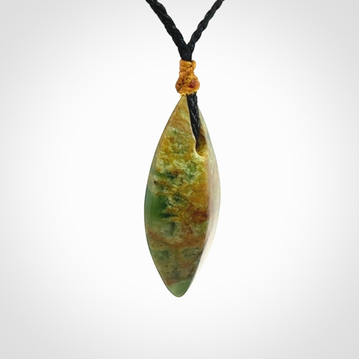 This picture shows a medium sized Flower Jade teardrop pendant. The pendant looks like a teardrop . A hand made unique and contemporary necklace hand carved here in New Zealand.