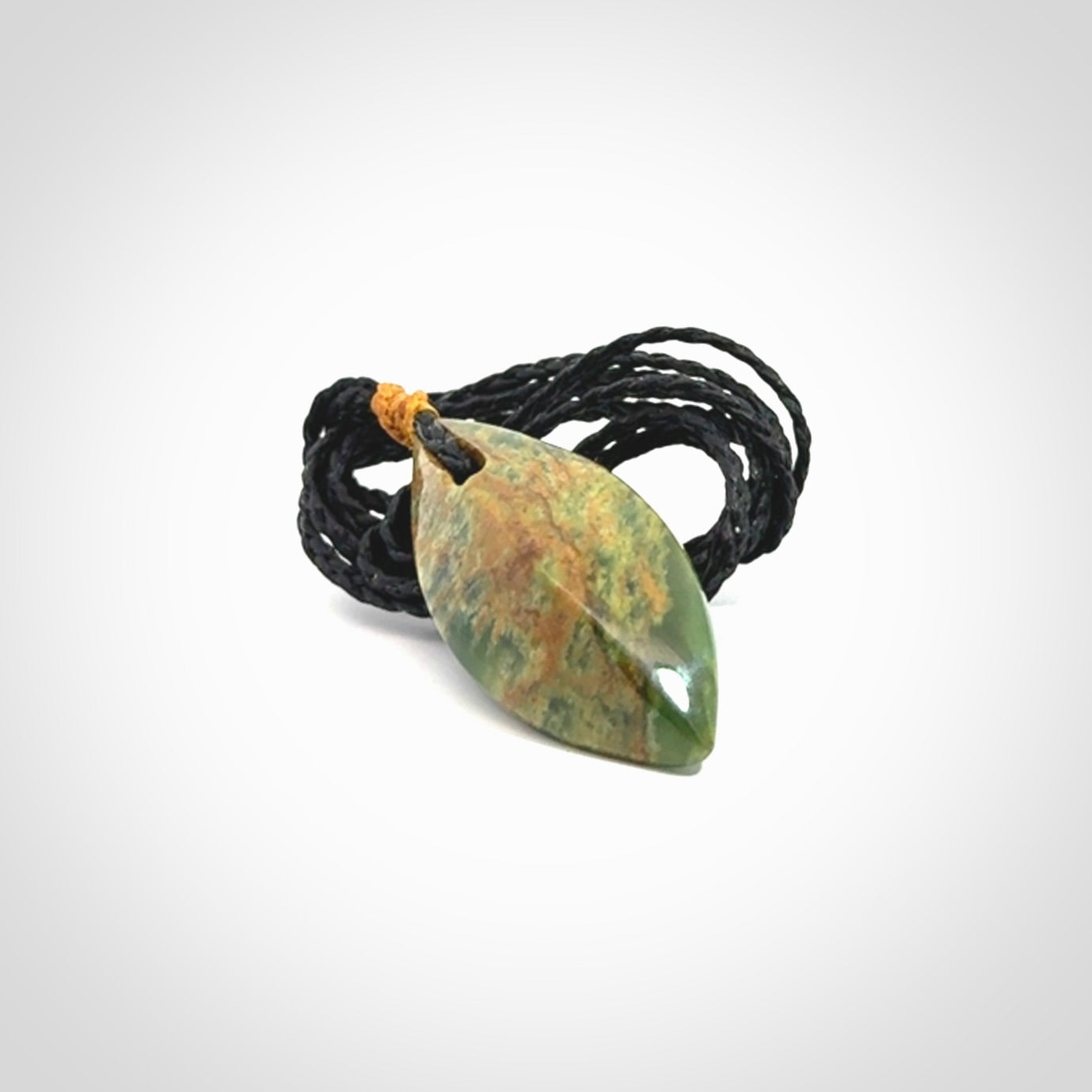 This picture shows a medium sized Flower Jade teardrop pendant. The pendant looks like a teardrop . A hand made unique and contemporary necklace hand carved here in New Zealand.