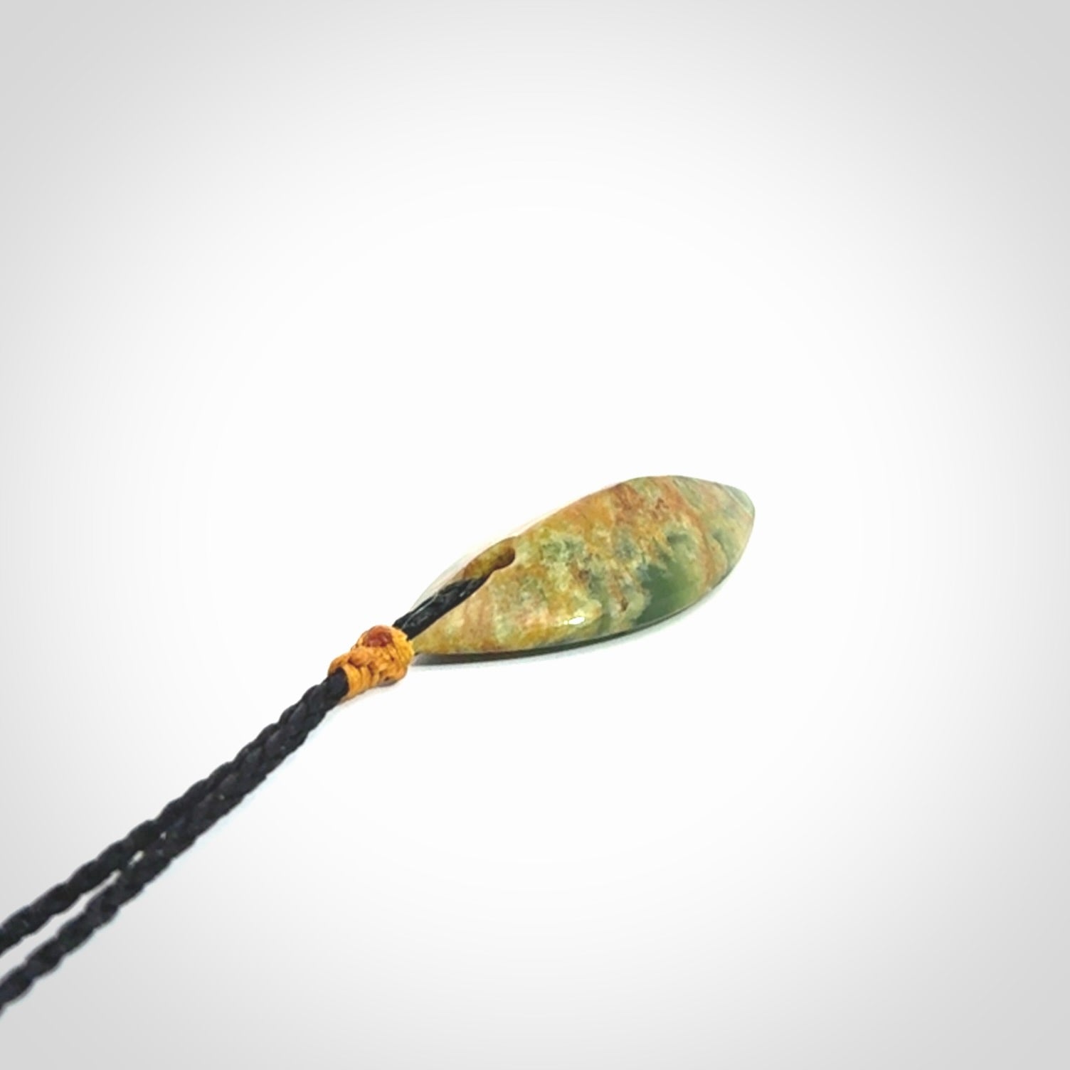 This picture shows a medium sized Flower Jade teardrop pendant. The pendant looks like a teardrop . A hand made unique and contemporary necklace hand carved here in New Zealand.