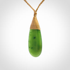 This picture shows a beautiful medium sized drop pendant carved in New Zealand Jade, pounamu. It is a lovely semi-translucent green colour, which is glows when held to the light. A gorgeous and very meaningful pendant with an adjustable cord.