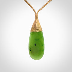 This picture shows a beautiful medium sized drop pendant carved in New Zealand Jade, pounamu. It is a lovely semi-translucent green colour, which is glows when held to the light. A gorgeous and very meaningful pendant with an adjustable cord.