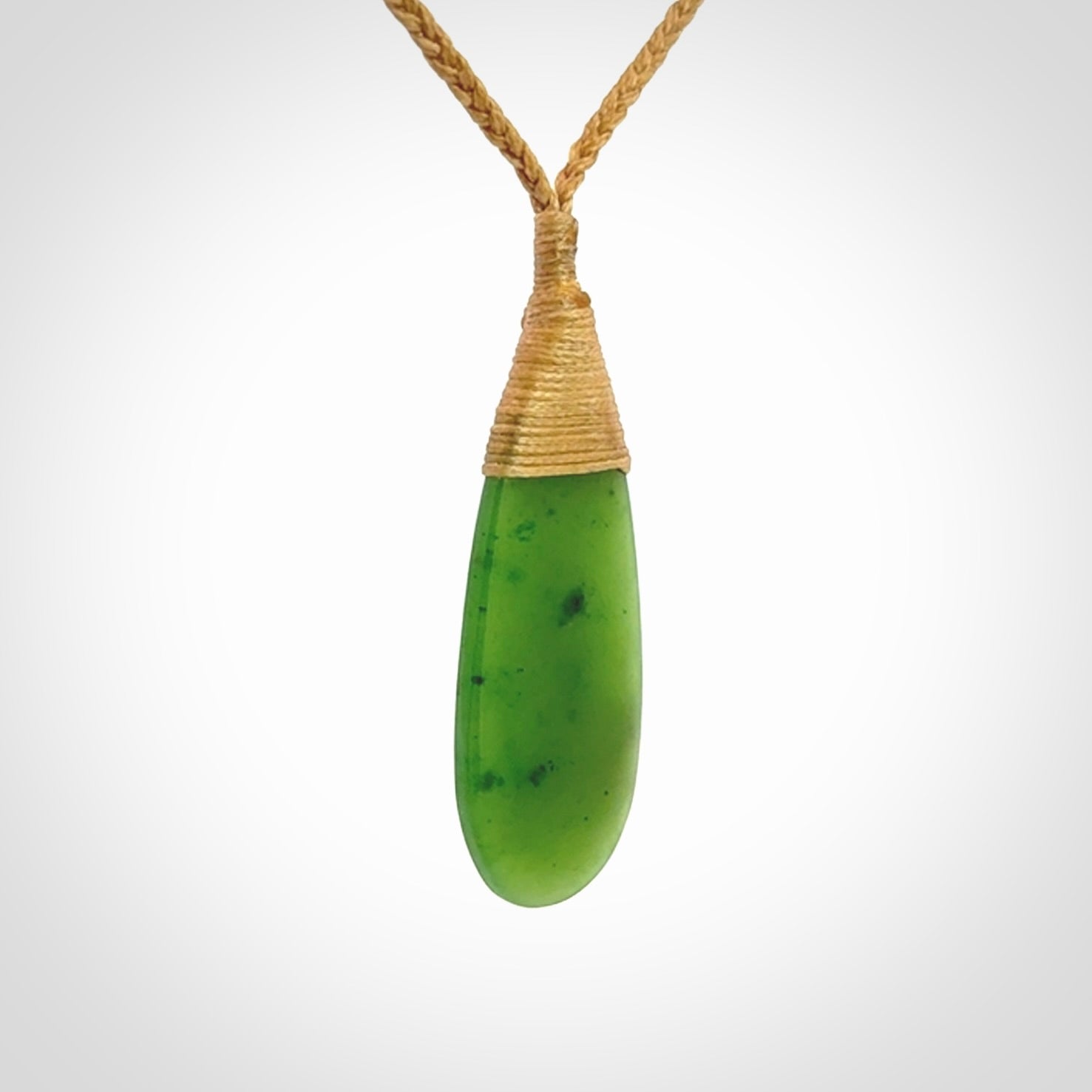 This picture shows a beautiful medium sized drop pendant carved in New Zealand Jade, pounamu. It is a lovely semi-translucent green colour, which is glows when held to the light. A gorgeous and very meaningful pendant with an adjustable cord.