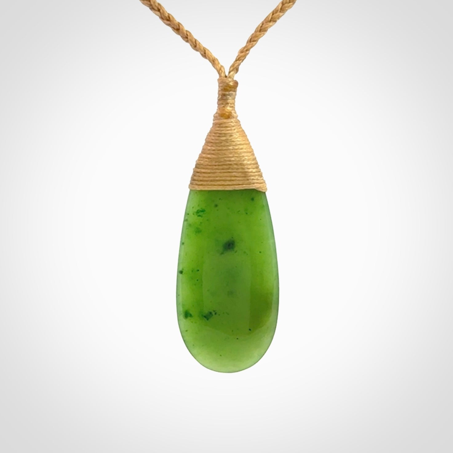 This picture shows a beautiful medium sized drop pendant carved in New Zealand Jade, pounamu. It is a lovely semi-translucent green colour, which is glows when held to the light. A gorgeous and very meaningful pendant with an adjustable cord.