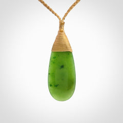 This picture shows a beautiful medium sized drop pendant carved in New Zealand Jade, pounamu. It is a lovely semi-translucent green colour, which is glows when held to the light. A gorgeous and very meaningful pendant with an adjustable cord.