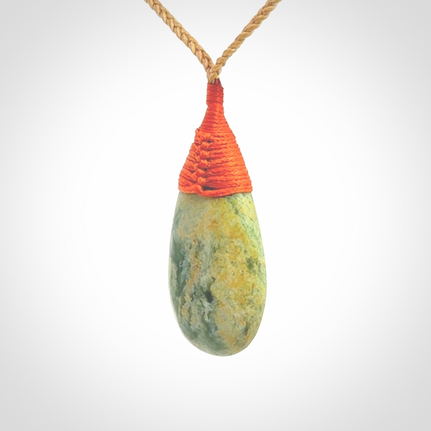This picture shows a beautiful medium sized drop pendant carved in New Zealand Jade, pounamu. It is a lovely green and yellow colour. A gorgeous and very meaningful pendant with an adjustable cord.
