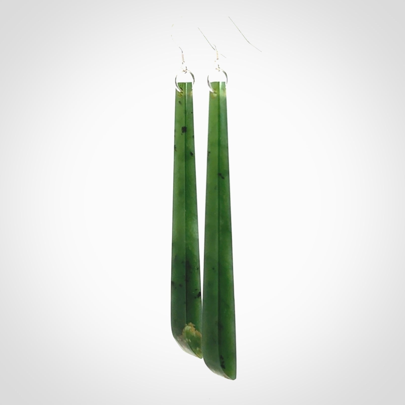 These are stunning large sized drop flower jade earrings carved in New Zealand. It is carved from a beautiful green piece of New Zealand Flower Jade and with Sterling Silver hooks and findings.
